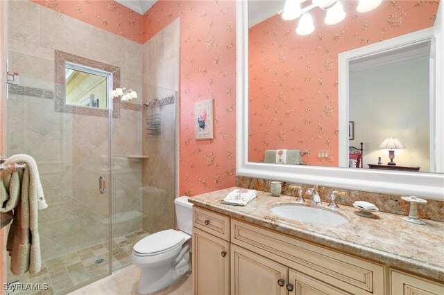 bathroom with vanity, an enclosed shower, and toilet