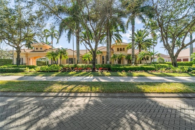 mediterranean / spanish-style house featuring a front lawn