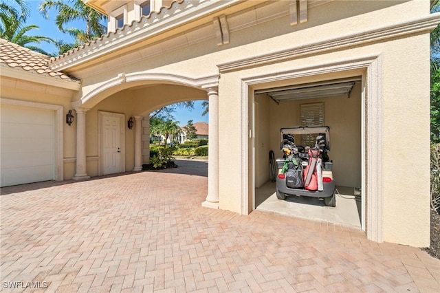 garage featuring decorative driveway