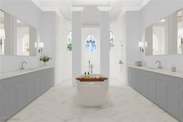 bathroom with marble finish floor, ornamental molding, and a sink