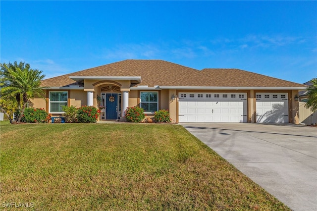 view of front of property with a garage and a front lawn