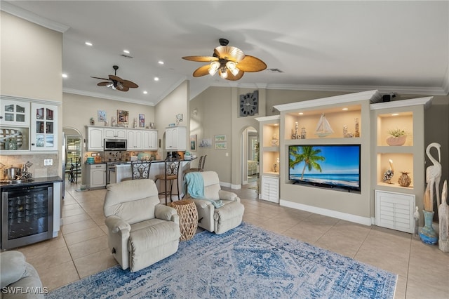 tiled living room featuring crown molding, high vaulted ceiling, beverage cooler, and ceiling fan