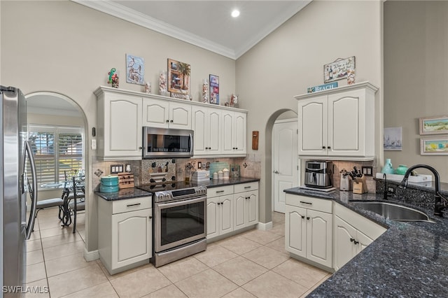 kitchen with white cabinetry, sink, crown molding, and stainless steel appliances