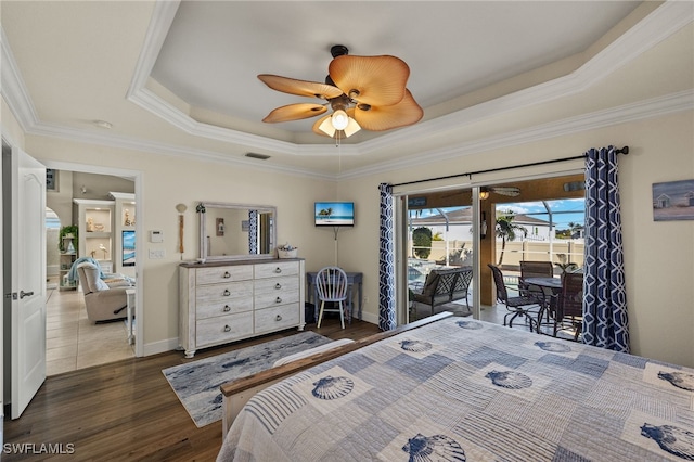 bedroom with a raised ceiling, ornamental molding, access to outside, and dark hardwood / wood-style flooring