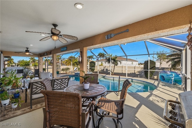 exterior space with a fenced in pool, a grill, ceiling fan, and glass enclosure