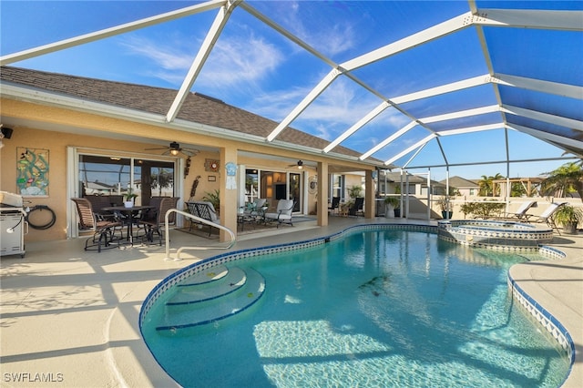 view of swimming pool featuring a patio, an in ground hot tub, grilling area, ceiling fan, and glass enclosure