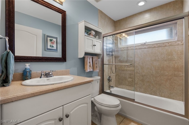 full bathroom with vanity, tile patterned flooring, shower / bath combination with glass door, and toilet