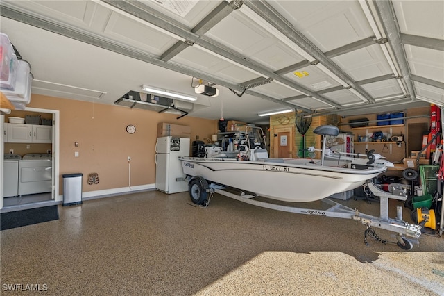 garage with a garage door opener, washing machine and dryer, and white fridge