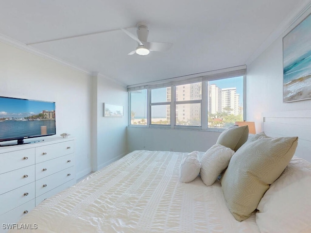 bedroom featuring multiple windows, crown molding, and ceiling fan