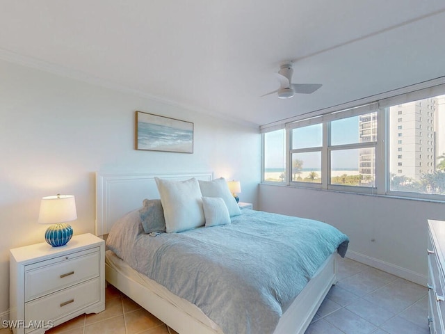 bedroom featuring multiple windows, light tile patterned floors, and ceiling fan