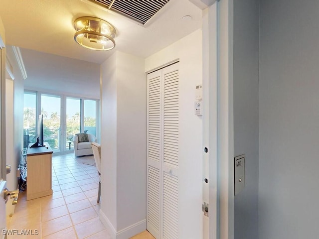 hall with light tile patterned floors