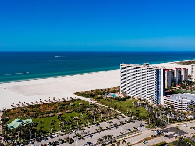 birds eye view of property with a water view and a beach view