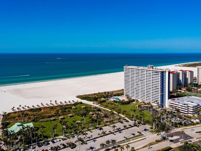 drone / aerial view with a beach view and a water view