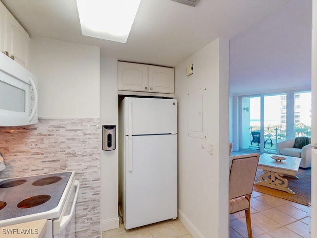 kitchen featuring white cabinetry, white appliances, and light tile patterned flooring