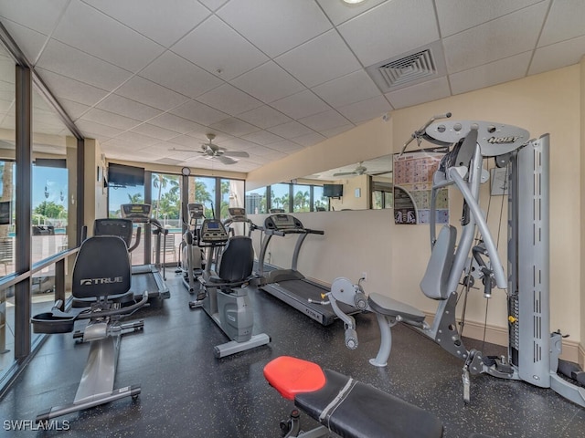 gym featuring visible vents, a ceiling fan, and a drop ceiling