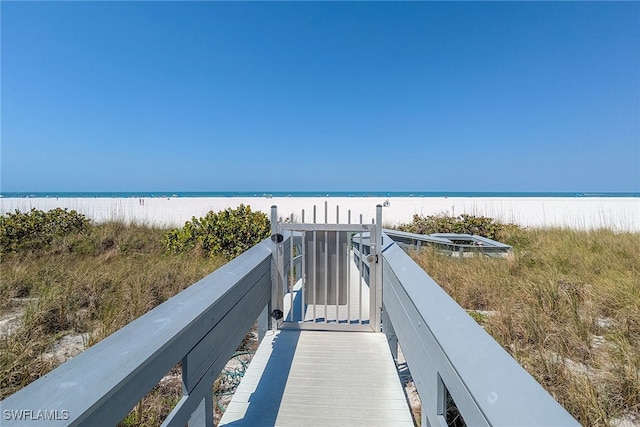 view of property's community featuring a beach view and a water view