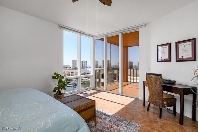 bedroom featuring light tile patterned flooring, floor to ceiling windows, and access to exterior