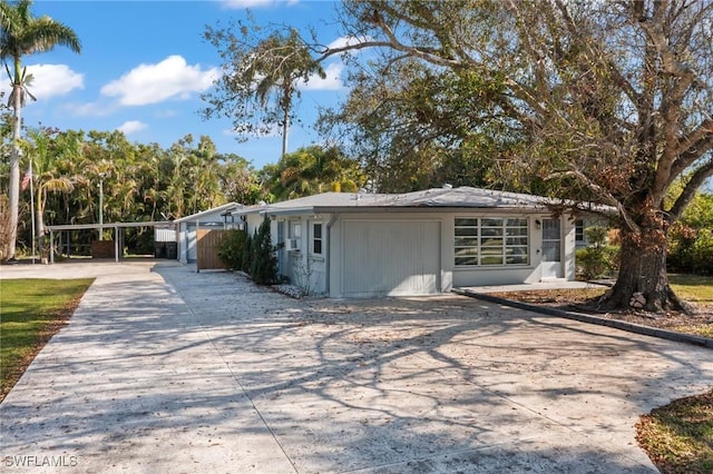 view of front of home featuring a garage and a carport