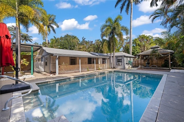 view of pool featuring a gazebo, an outdoor structure, and a patio area