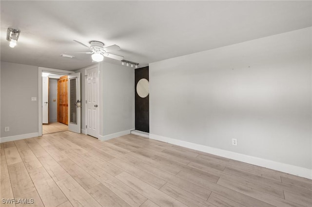 unfurnished room featuring ceiling fan and light wood-type flooring