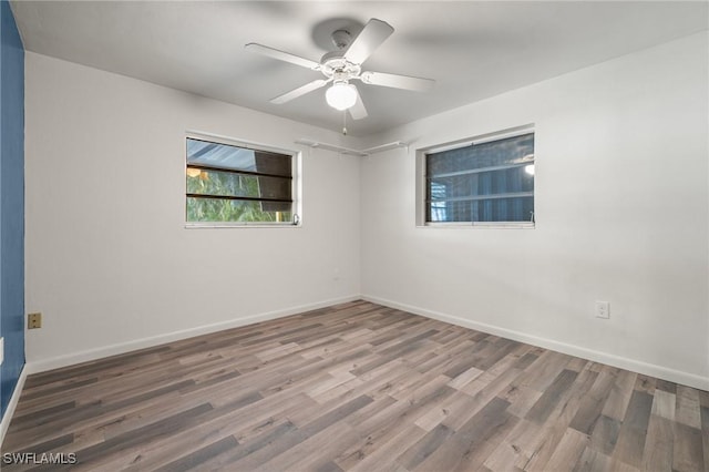 unfurnished room with ceiling fan and hardwood / wood-style floors