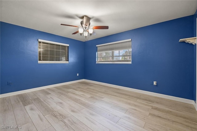 empty room with ceiling fan and light wood-type flooring