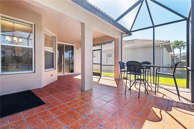 view of patio featuring glass enclosure