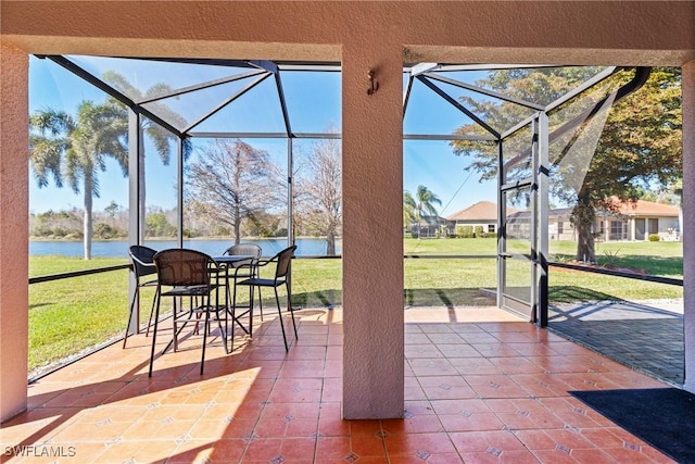 sunroom / solarium featuring a water view and a healthy amount of sunlight