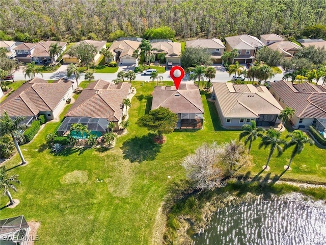 birds eye view of property with a water view