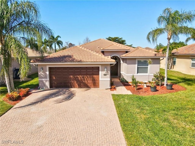 mediterranean / spanish home featuring a garage and a front lawn