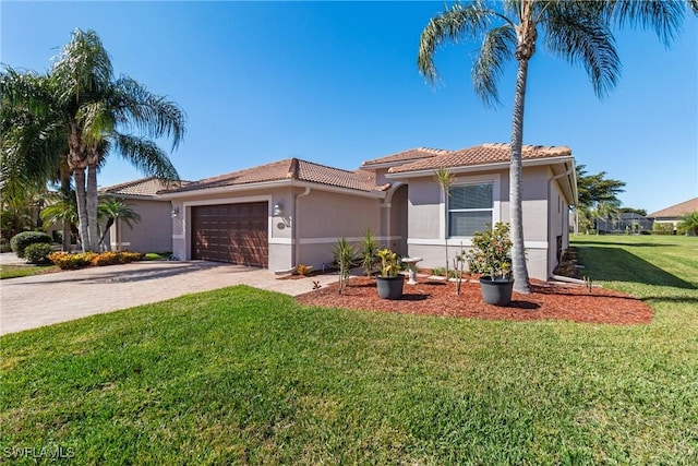 mediterranean / spanish home with a garage and a front yard