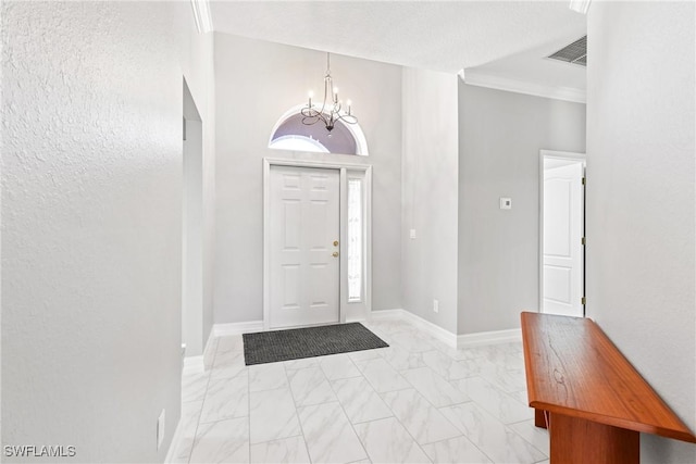 entrance foyer featuring crown molding and an inviting chandelier