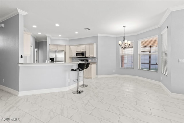 kitchen with crown molding, appliances with stainless steel finishes, a breakfast bar area, and decorative light fixtures