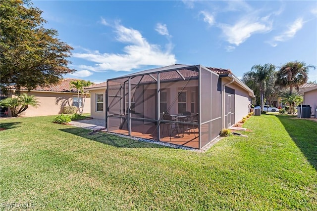 back of house with a patio, a lanai, and a yard