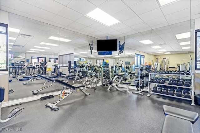 gym with a paneled ceiling