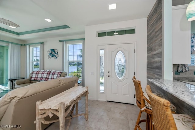 entrance foyer with a tray ceiling