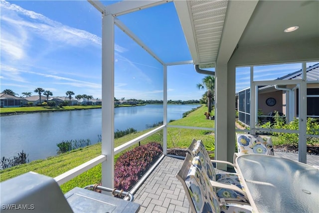 sunroom / solarium with a water view