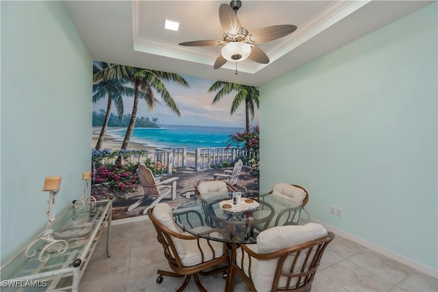 dining room with crown molding, a raised ceiling, ceiling fan, and light tile patterned flooring