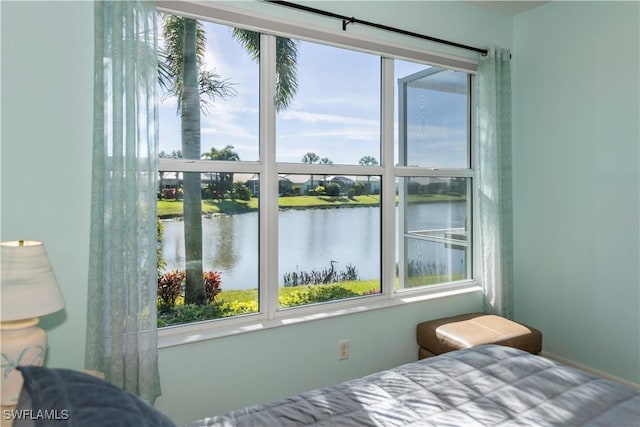 bedroom featuring a water view