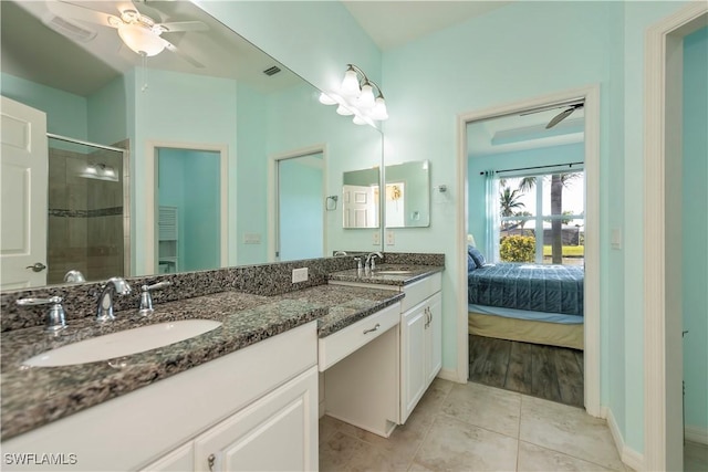 bathroom featuring tile patterned flooring, vanity, a shower with door, and ceiling fan