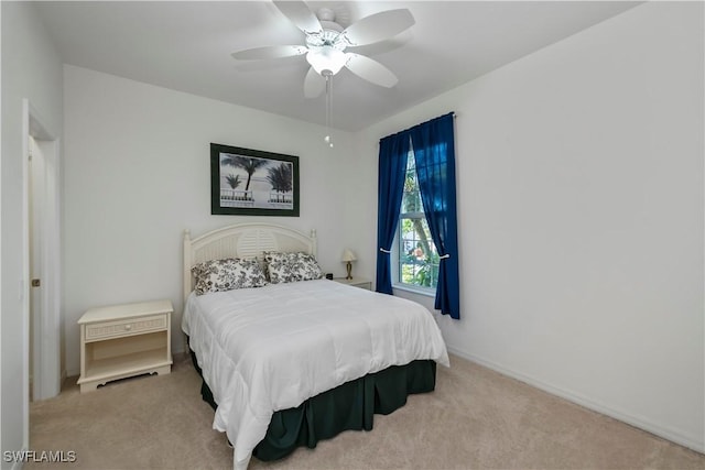 bedroom featuring light carpet and ceiling fan