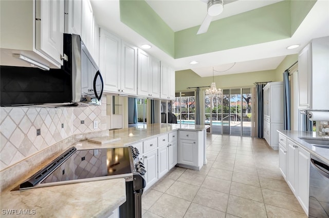 kitchen featuring range with electric stovetop, dishwashing machine, kitchen peninsula, pendant lighting, and white cabinets