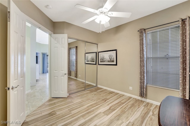 bedroom with light hardwood / wood-style floors, a closet, and ceiling fan