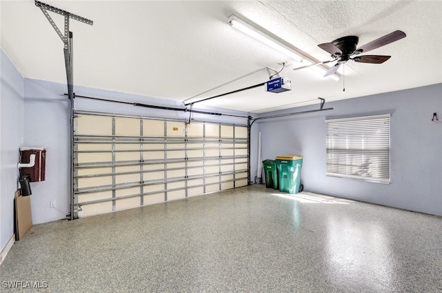 garage with ceiling fan and a garage door opener