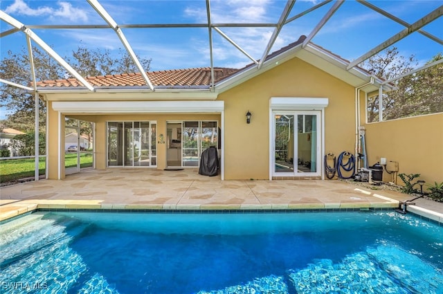 rear view of property featuring a lanai and a patio