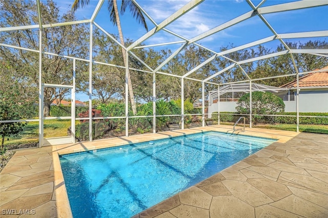 view of pool with a lanai and a patio area