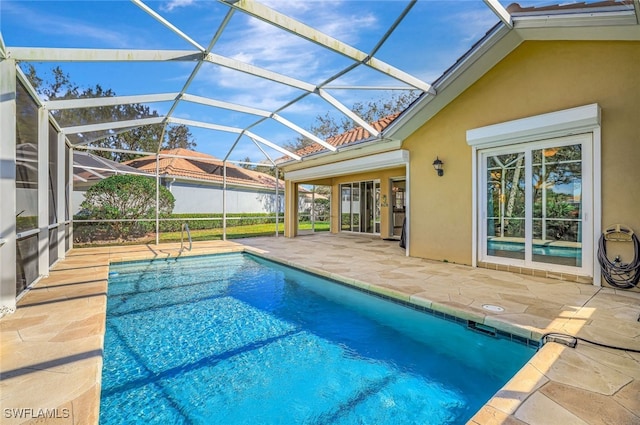 view of swimming pool with a lanai and a patio