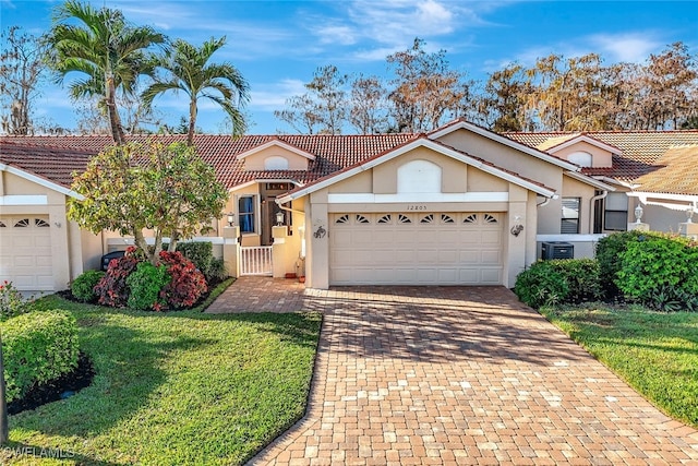 ranch-style home featuring a garage and a front lawn