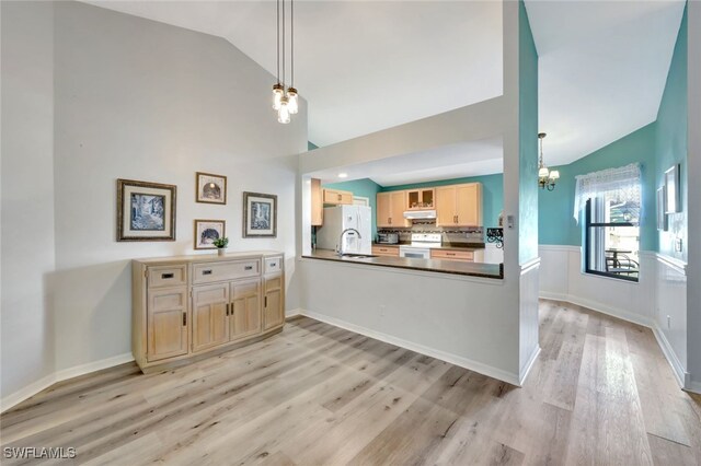 kitchen featuring pendant lighting, white appliances, light hardwood / wood-style flooring, kitchen peninsula, and light brown cabinets