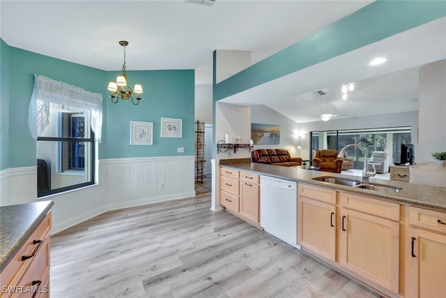 kitchen featuring lofted ceiling, sink, dishwasher, light hardwood / wood-style floors, and light brown cabinetry